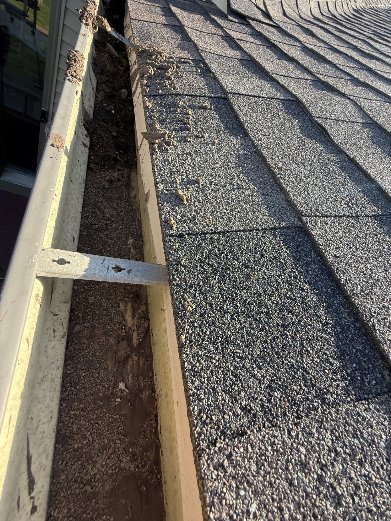 Gutter packed with debris before cleaning